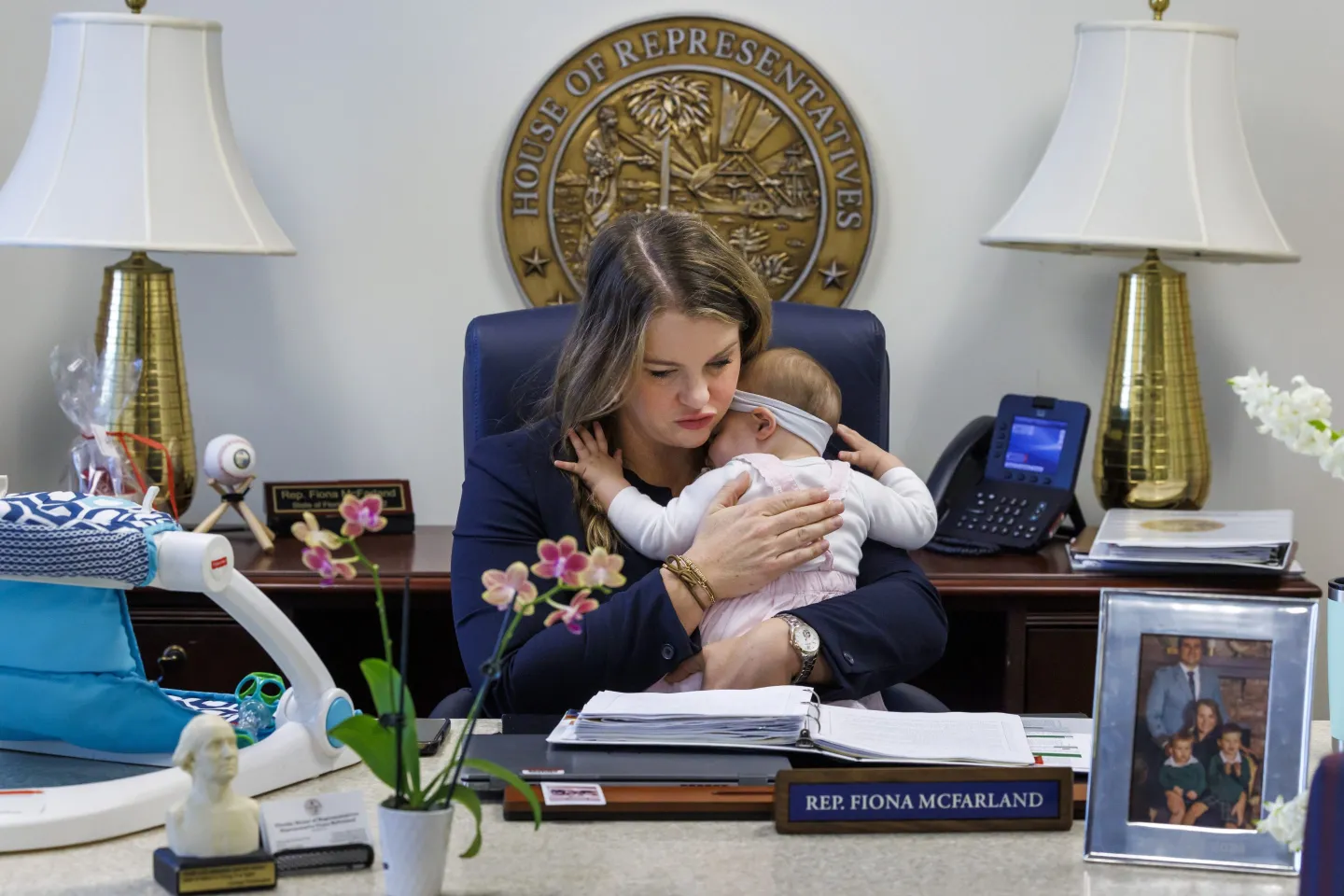 A congresswoman holds her baby in her office