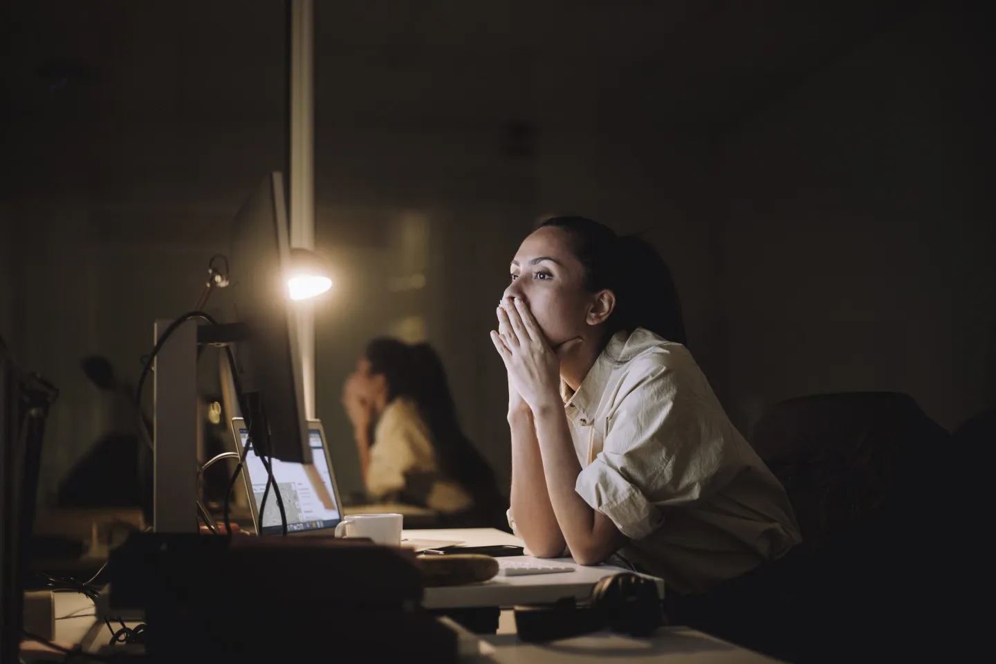 Businesswoman working late at night at office.