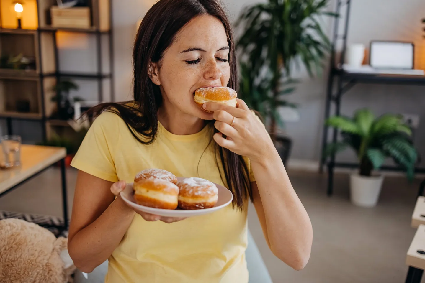 Closeup of woman eating doughnuts