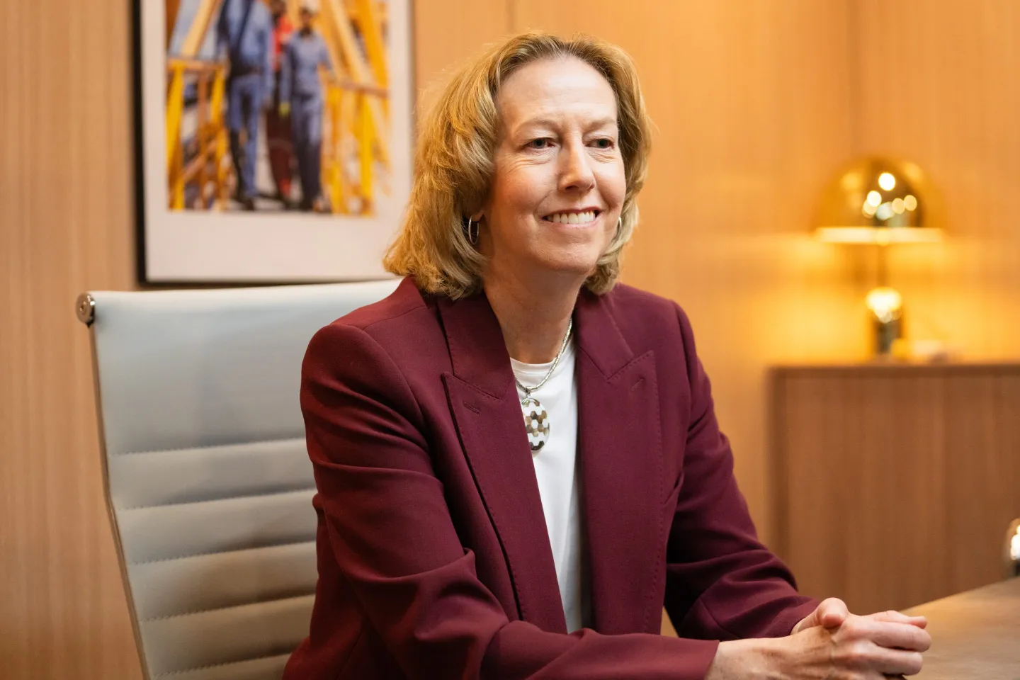 Woodside Energy CEO Meg O'Neill speaks while seated on the sidelines of an energy conference.