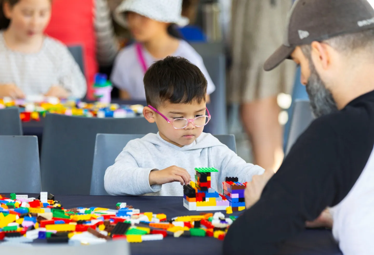 A boy plays with Lego bricks.