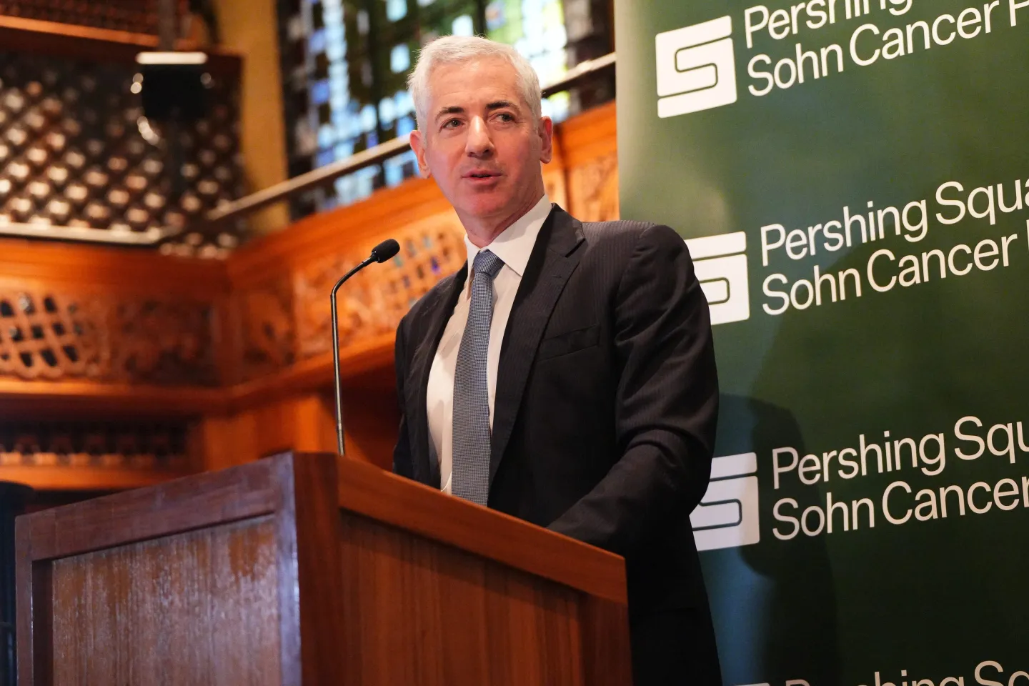 Bill Ackman stands at a podium