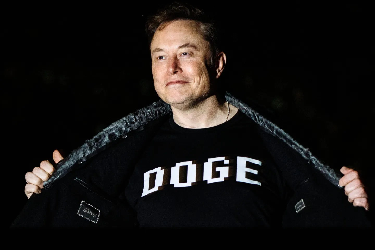 Elon Musk wearing a DOGE t-shirt.