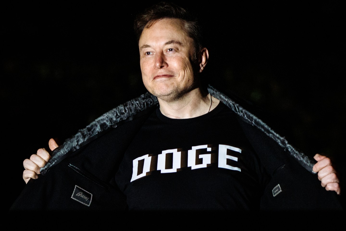 Elon Musk is wearing a DOGE t-shirt.