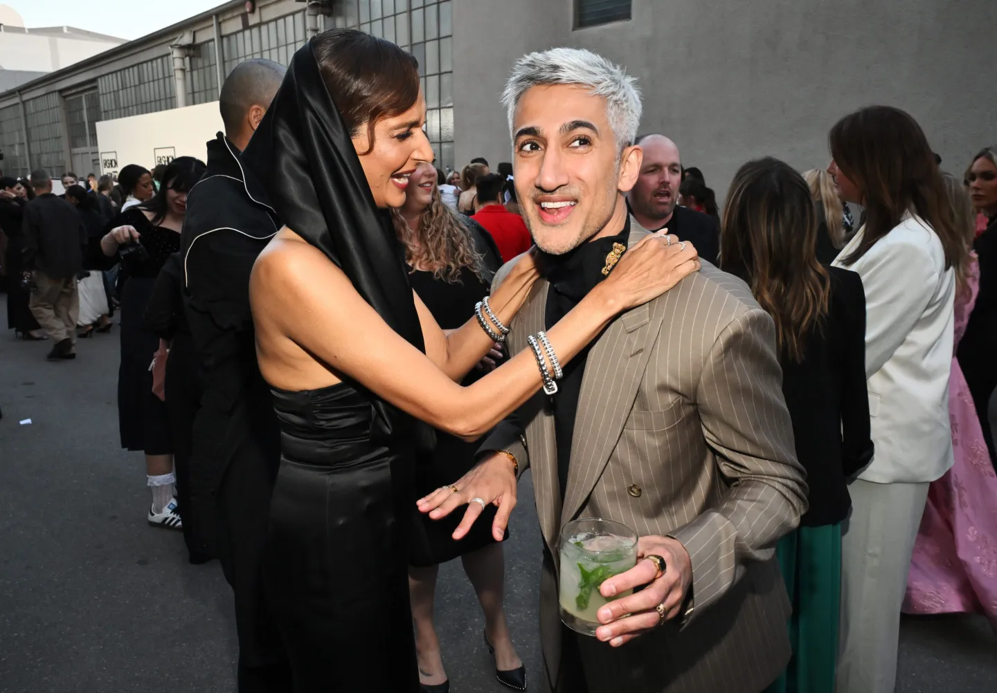 Poorna Jagannathan with her hands on the shoulders of fashion designer, stylist and entreprenuer Tan France outside a fashion awards show in Los Angeles.