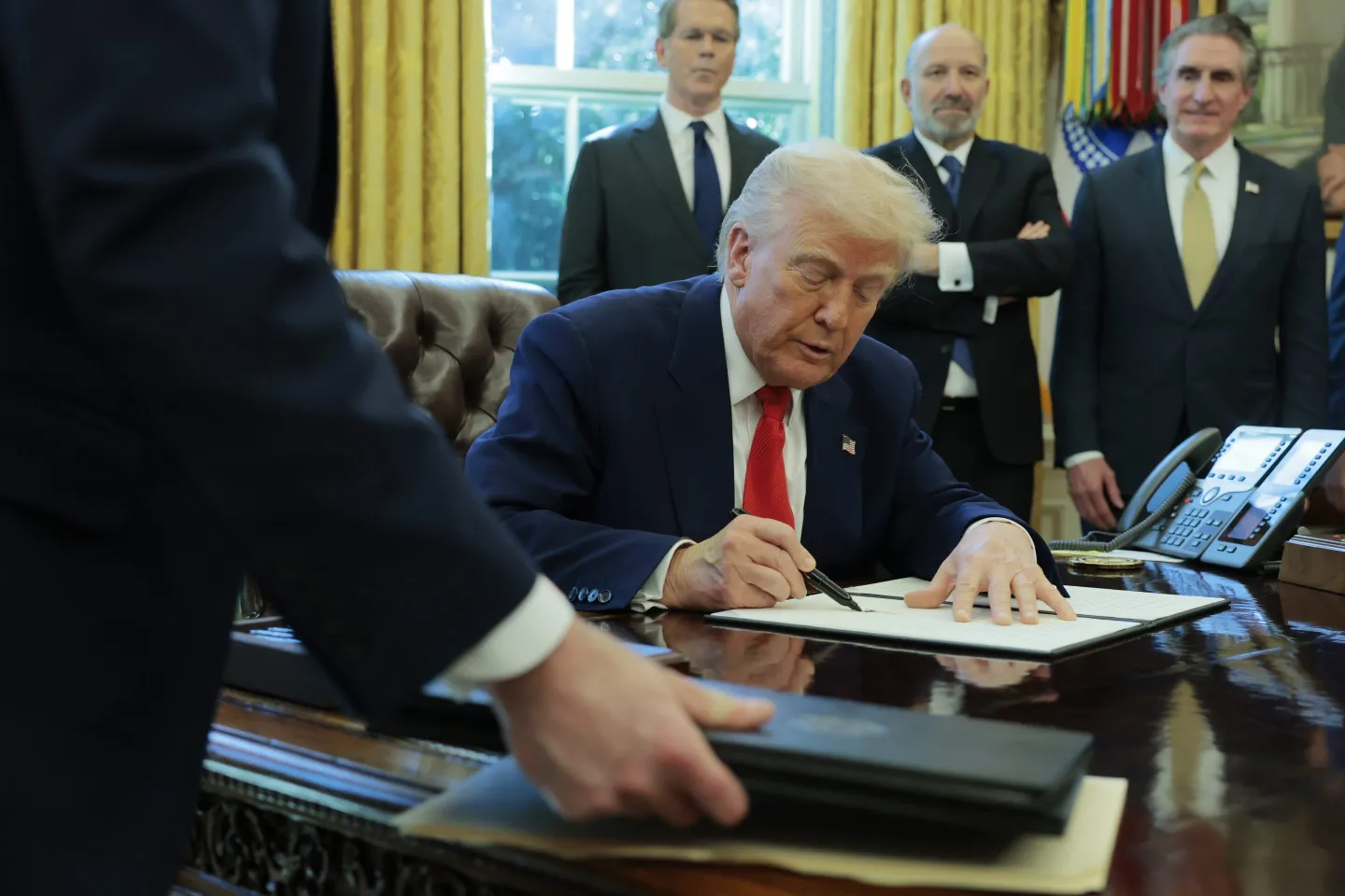 President Donald Trump signs a executive order as (left-to-right) U.S. Treasury Secretary Scott Bessent, Secretary of Commerce Howard Lutnick and Interior Secretary Doug Burgum look on in the Oval Office of the White House on April 09, 2025 in Washington, DC.